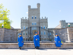 2021 grads pose in front of the Old Main gate by Jay Grabiec