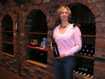 Woman Showing a Bottle of Wine at Cameo Vineyards by Daily Eastern News
