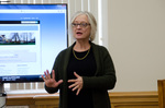 Professor Lynne Curry explains her students' research projects by Bev Cruse